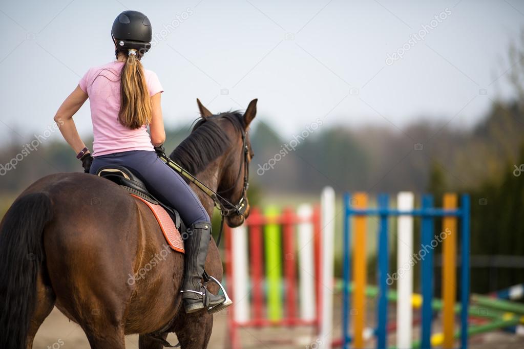 Woman show jumping with horse