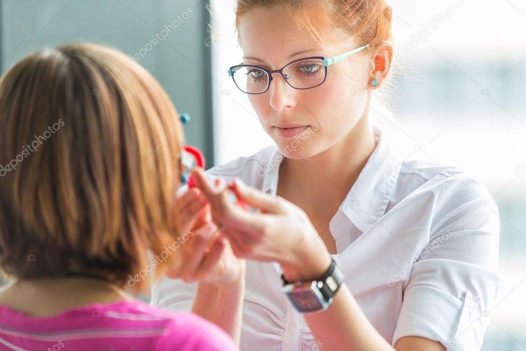 Optometry concept - pretty, young female optometrist