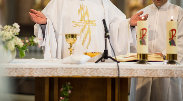 Priest during a wedding ceremonym- nuptial mass