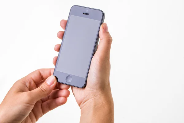 Vrouwelijke hand met een slimme telefoon — Stockfoto