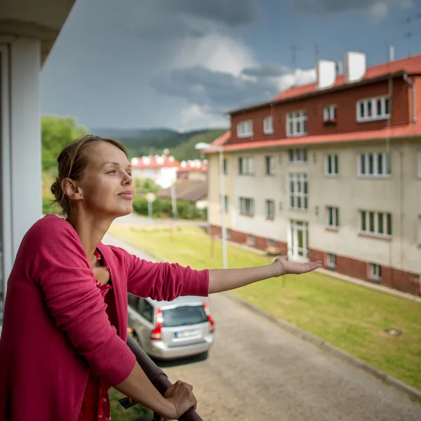 Woman checking wether it is raining already — Stock Photo, Image