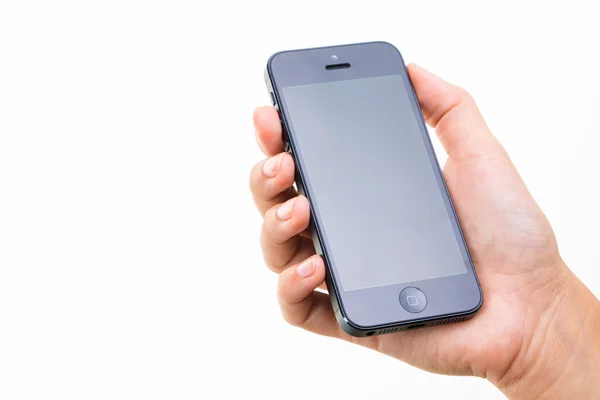 Vrouwelijke hand met een slimme telefoon, geïsoleerd op wit — Stockfoto