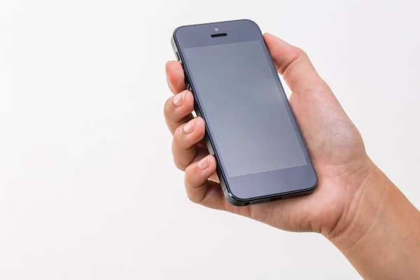 Mão feminina segurando um telefone inteligente, isolado no branco — Fotografia de Stock