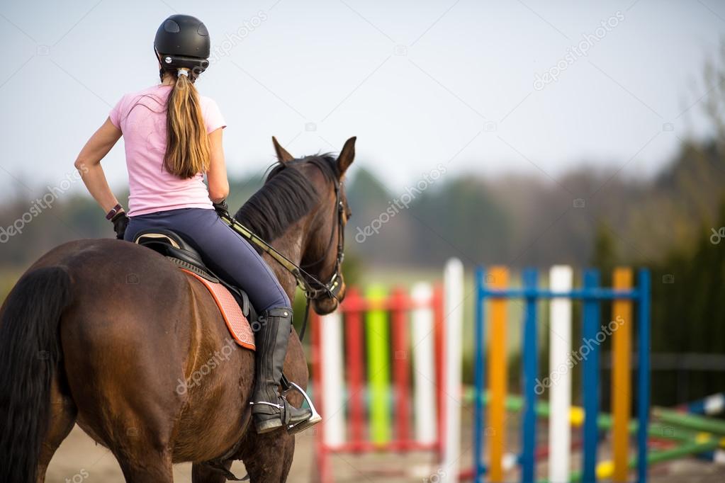 Woman show jumping with horse