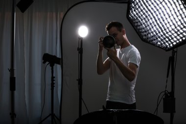 Young pro photographer with digital camera clipart