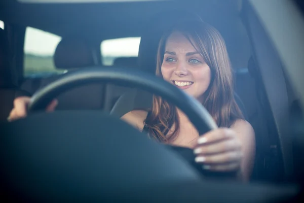 Cute teenager driving her brand new car — Stock Photo, Image