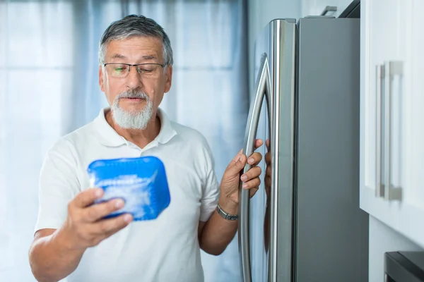 Isto ainda está bem? Homem sênior em sua cozinha perto da geladeira — Fotografia de Stock