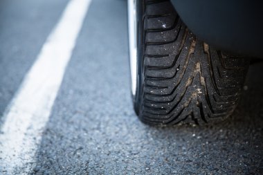 Detail of the tyre of a modern car on road 