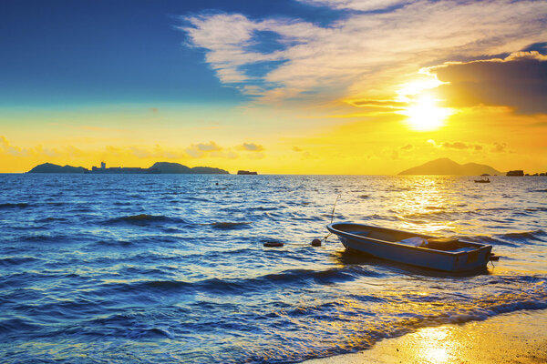 Boat on a sea coast at sunset