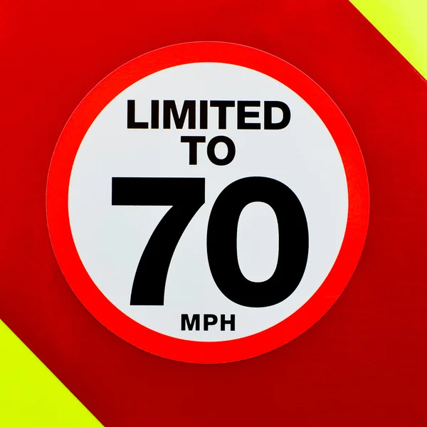 Speed limited sign on the back of a vehicle with high visibility chevrons — Stock Photo, Image