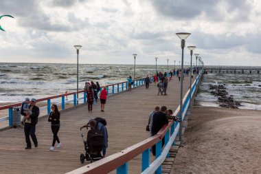 PALANGA,LITHUANIA-AUGUST 23, 2019:Boardwalk pier in Baltic Sea udnder cloudy sky, Palanga,Lithuania,Europe
