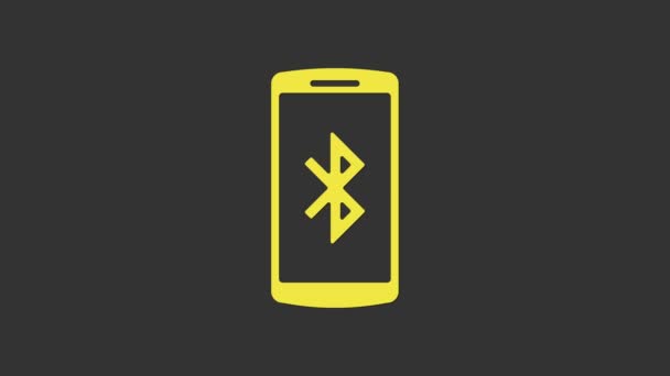 Smartphone jaune avec icône de symbole Bluetooth isolé sur fond gris. Animation graphique de mouvement vidéo 4K — Video