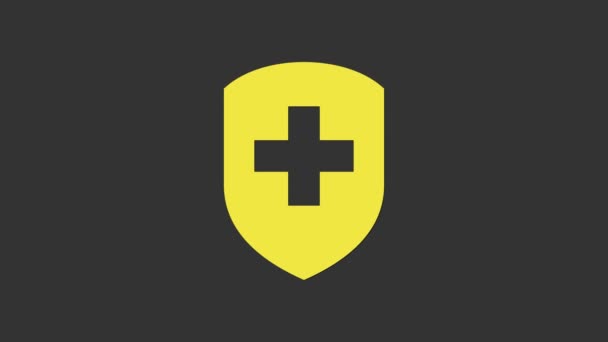 Bouclier médical jaune avec icône croix isolée sur fond gris. Protection, sécurité, mot de passe. Animation graphique de mouvement vidéo 4K — Video