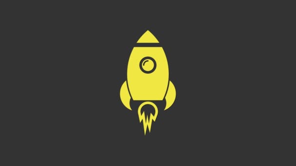 Yellow Rocket ship with fire icon isolated on grey background. Space travel. 4K Video motion graphic animation — Stock Video