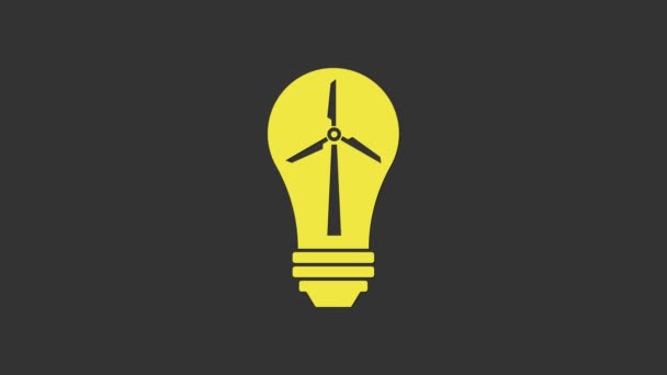 Yellow Light bulb with wind turbine as idea of eco friendly source of energy icon isolated on grey background. Alternative energy concept. 4K Video motion graphic animation — Stock Video