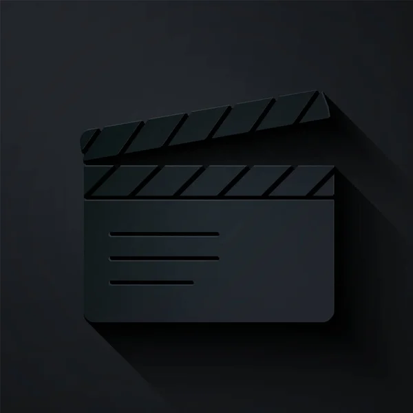 Papiergeschnittenes Movie clapper icon isoliert auf schwarzem Hintergrund. Filmklappbrett. Klappschild. Kinoproduktion oder Medienindustrie. Papierkunst. Vektor — Stockvektor