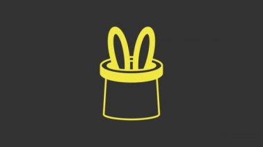 Sarı Sihirbaz şapkası ve tavşan kulağı simgesi gri arka planda izole edilmiş. Sihir numarası. Gizemli eğlence konsepti. 4K Video hareketli grafik canlandırması