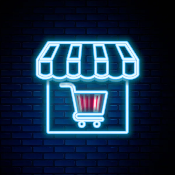 Glödande neon line Shopping byggnad eller butik med kundvagn ikon isolerad på tegel vägg bakgrund. Butikskonstruktion. Korgsymbol för snabbköp. Färgstarkt skisskoncept. Vektor — Stock vektor