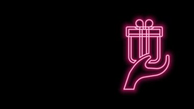 Parlayan neon hattı siyah arkaplanda izole edilmiş hediye simgesi ver. Hediye elinde. Hediye verme ve alma kavramı. 4K Video hareketli grafik canlandırması