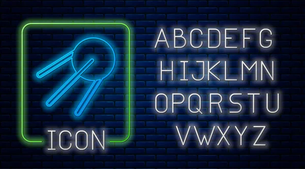 Glowing neon Satellite icon isolated on brick wall background. Neon light alphabet. Vector — Stock Vector
