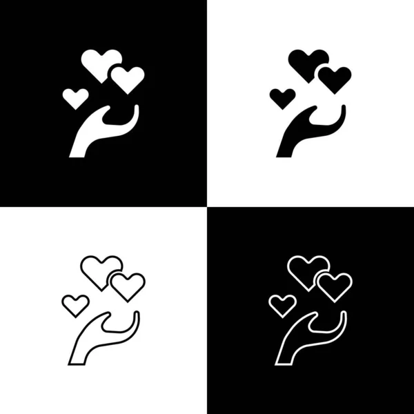 Set Corazón en mano icono aislado sobre fondo blanco y negro. Mano dando símbolo de amor. Símbolo de San Valentín. Vector — Vector de stock