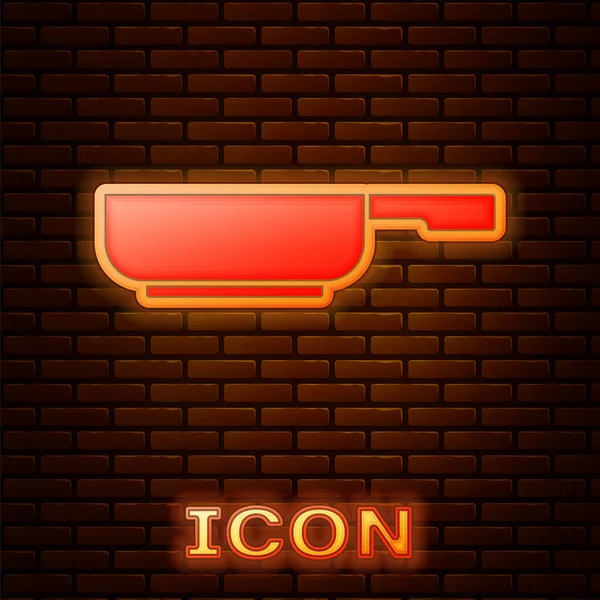 Glödande neon Stekpanna ikon isolerad på tegelvägg bakgrund. Stek eller stekt mat symbol. Vektor — Stock vektor