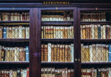 Bologna, Italy - September 30, 2019: Books in Municipal Library located in Archiginnasio - one of the oldest buildings of Bologna University clipart