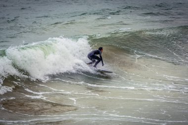 San Sebastian, Spain - January 28, 2019: Surfer on La Concha Bay in San Sebastian city also known as Donostia clipart