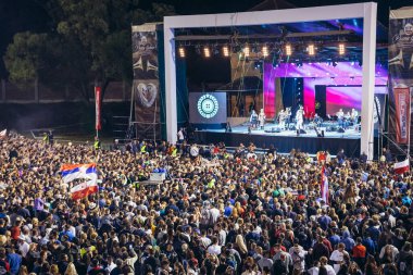 Guca, Serbia - August 13, 2017: Bijelo Dugme concert during the Trumpet Festival in Guca village clipart