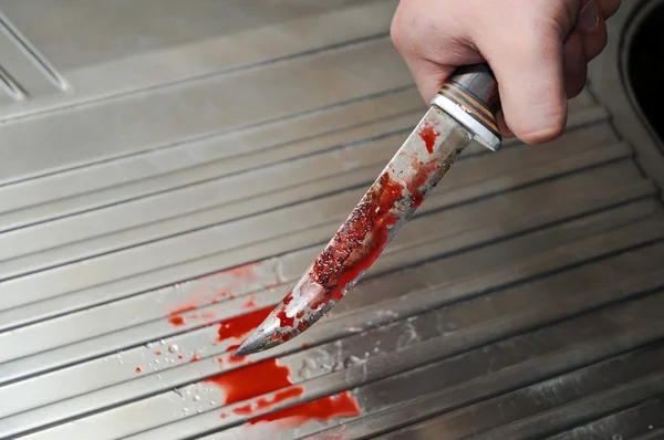 Hand with bloody knife — Stock Photo, Image