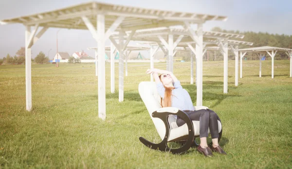 Beautiful happy woman relax in chair on lake morning — Stock Photo, Image