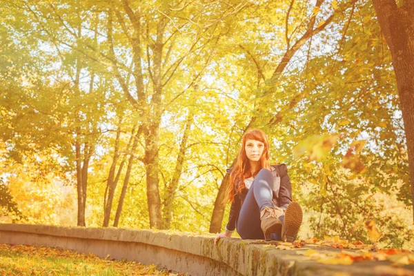 Woman with freckles and red long hair in fall park — Stock Photo, Image