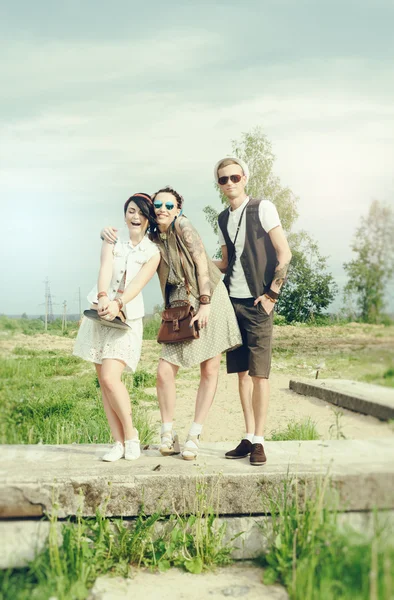 Young active girls and guy hipsters have fun outdoors — Stock Photo, Image