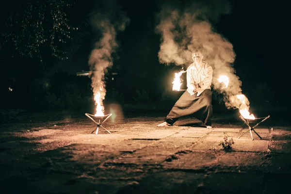 Active European guy carries out tricks for fire show night — Stock Photo, Image