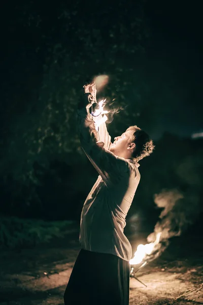 Active European guy carries out tricks for fire show night — Stock Photo, Image