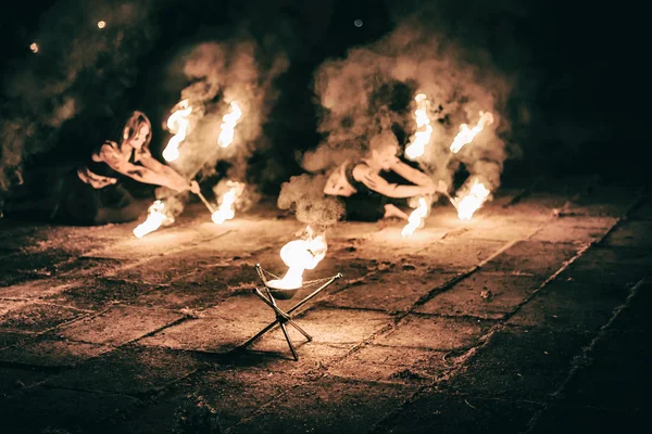 Active girls carries out tricks for fire show at night — Stock Photo, Image