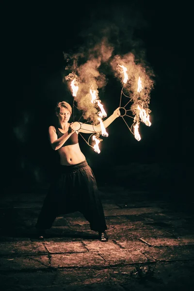 Chicas activas lleva a cabo trucos para el espectáculo de fuego en la noche — Foto de Stock