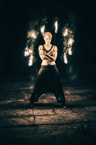 Active girls carries out tricks for fire show at night — Stock Photo, Image