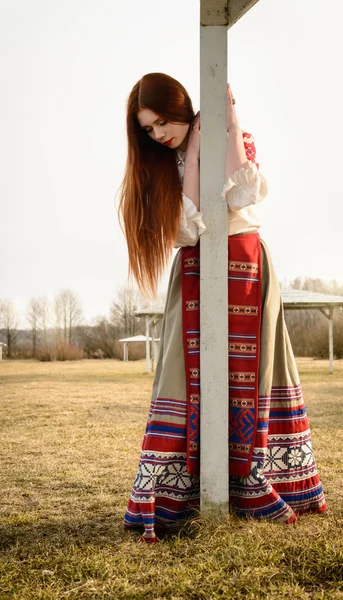 Jonge vrouw in Slavische Wit-Russische nationale oorspronkelijke pak buitenshuis — Stockfoto