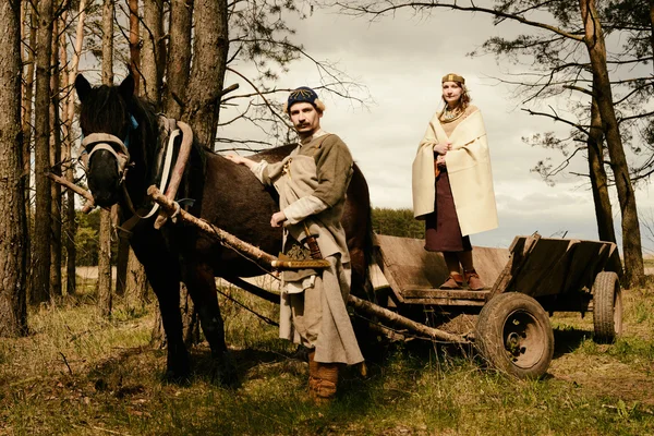 Woman and man in ethnic suit  context historical reconstruction — Stock Photo, Image