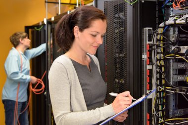 Woman IT engineer in server room clipart