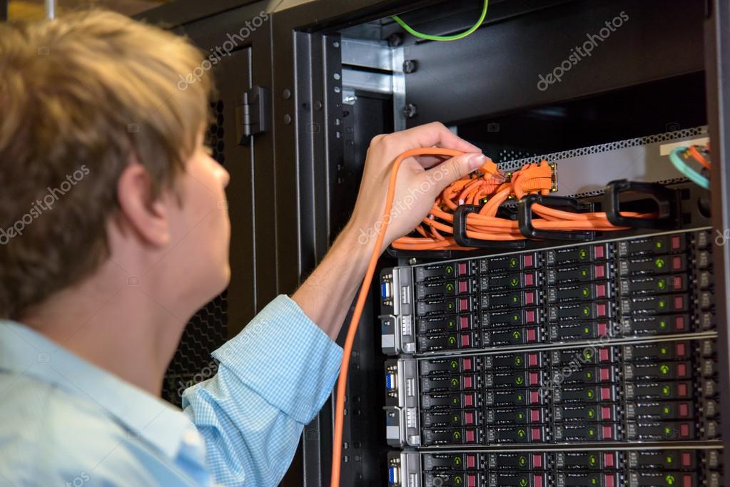 IT specialist patching network wire Stock Photo by ©CandyBoxImages 80021806