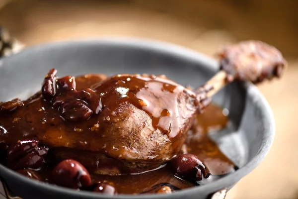 Roasted duck leg in red wine cherry sauce — Stock Photo, Image