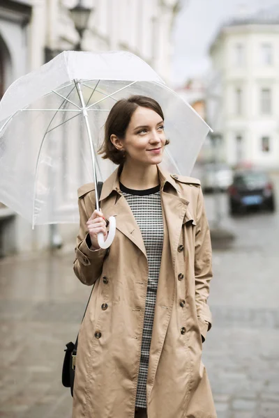 Woman at coat on wet street after rain — Stock Photo, Image