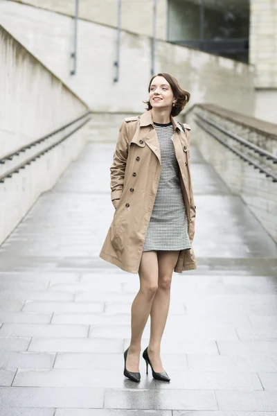 Woman at loose beige coat in good mood Royalty Free Stock Images