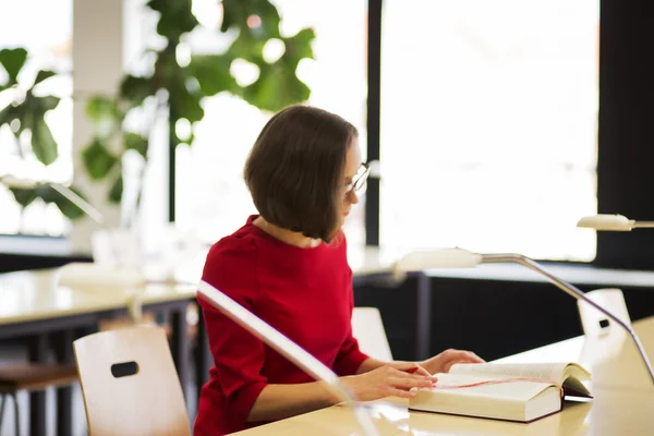 Woman in library read book at day — Stock Photo, Image