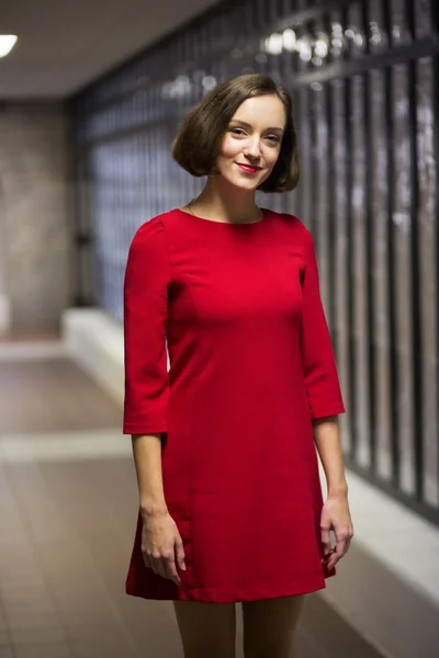 Woman in library hallway in good mood — Stock Photo, Image