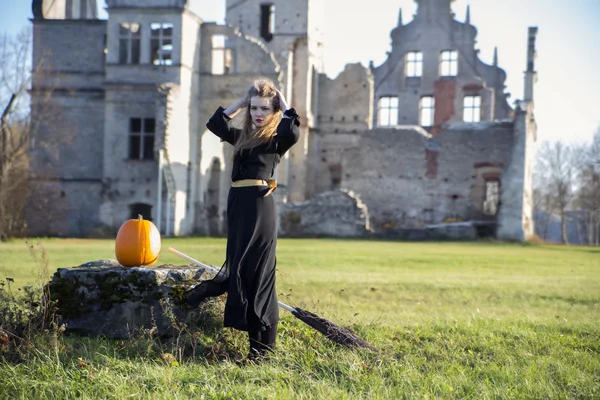 Witch with pale skin and pumpkin — Stock Photo, Image