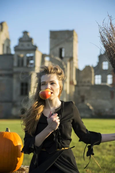 Witch with pale skin eating at windy day — Stock Photo, Image