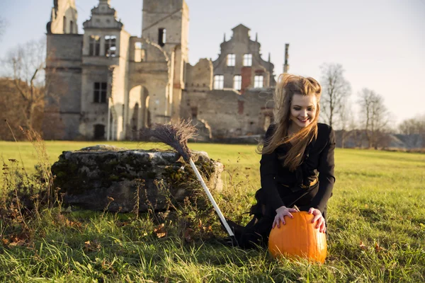 Witch with pale skin with pumpkin — Stock Photo, Image
